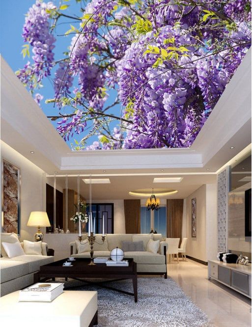 a living room filled with lots of furniture under a purple flower covered skylight ceiling