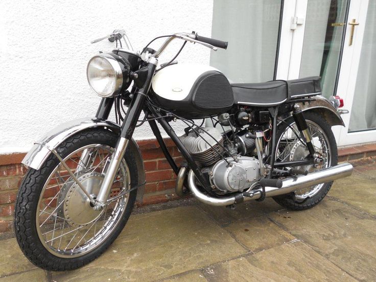 a black and white motorcycle parked next to a building