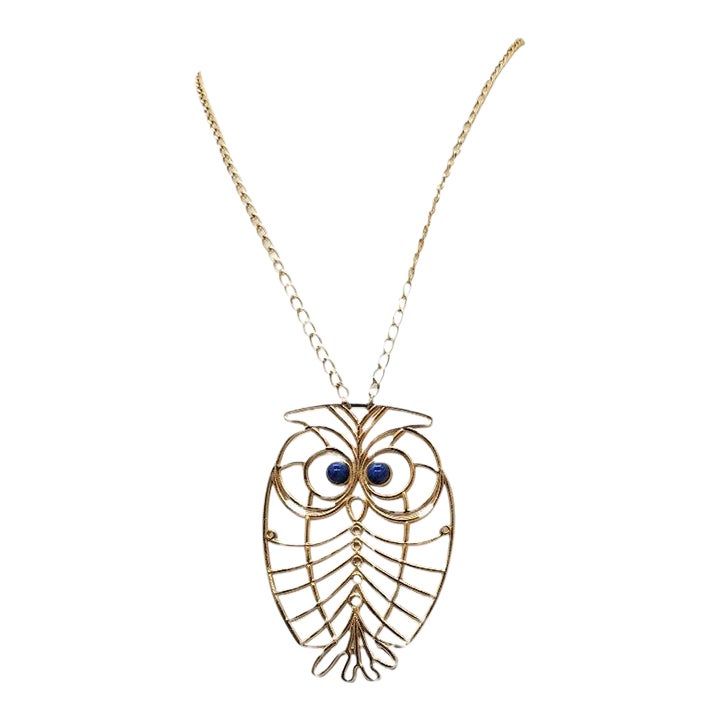 This is part of Chairish’s Costume Jewelry assortment.  Mid 1960s to 1970s goldtone owl with cabochon faux-lapis eyes pendant necklace with spring ring clasp. Marked "Napier."  Chain doubled measures: 12 inches. Pendant measures: 3 1/2 inches long by 2 1/2 inches wide. Condition: very good; minor wear to spring ring clasp. Owl Pendant Necklace, Owl Pendant, Accessories Jewelry Necklace, Modern Branding, Vintage Signs, Spring Rings, Vintage Necklace, Costume Jewelry, Gold Tones