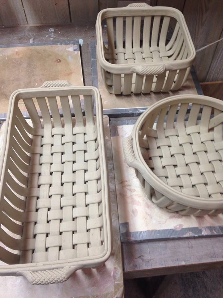 three plastic chairs sitting on top of a wooden table