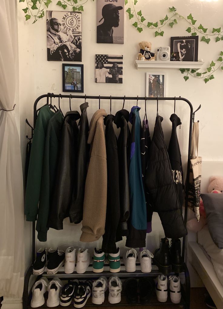 there are many coats and shoes hanging on the rack