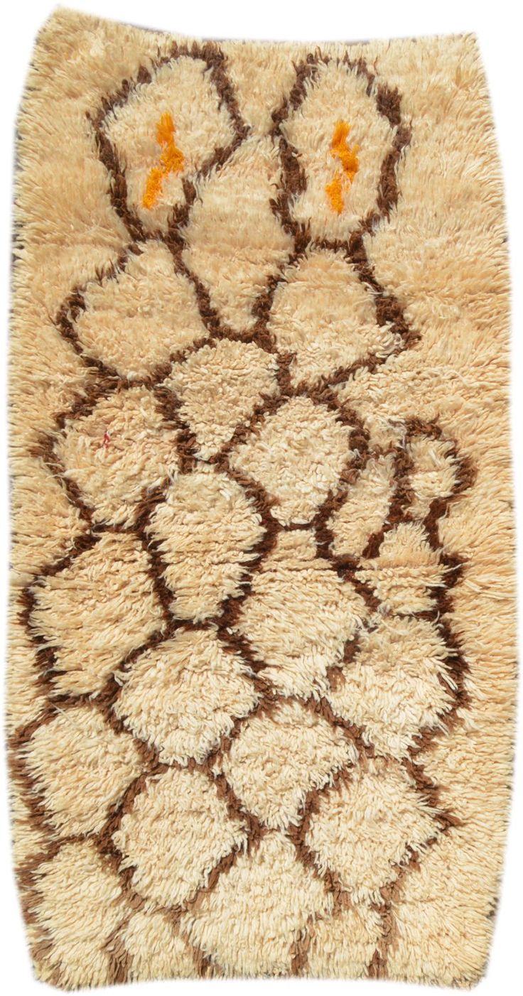 an animal rug with brown and white designs on it's back end, in front of a white background