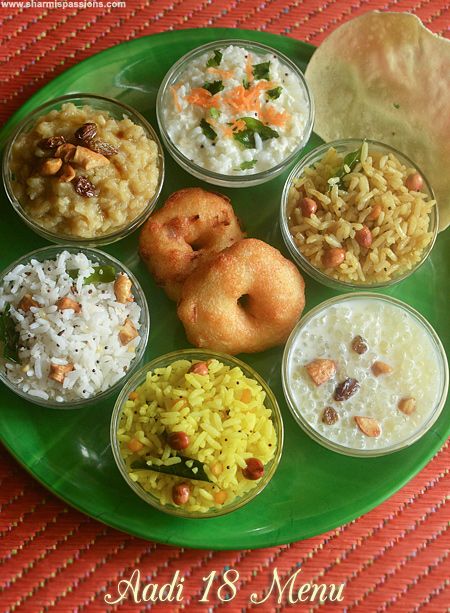 a green plate filled with different types of food on top of a red table cloth