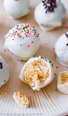 white frosted donuts with sprinkles on a plate