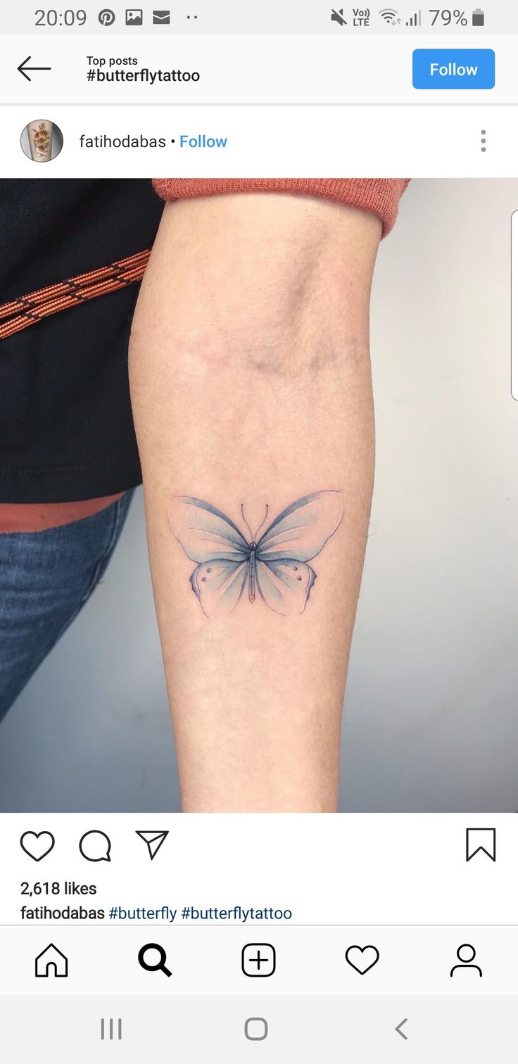 a small butterfly tattoo on the leg