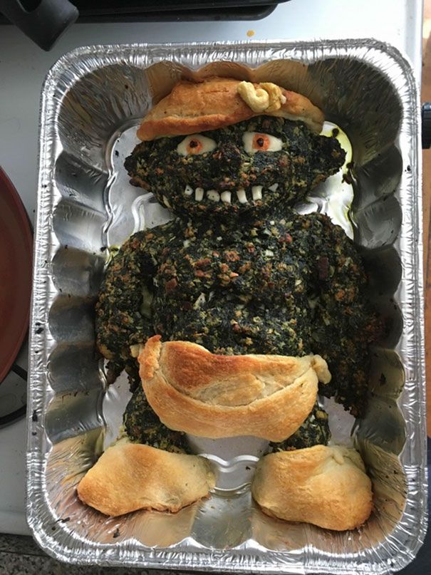 there is a metal pan with some food in the shape of a monster on it