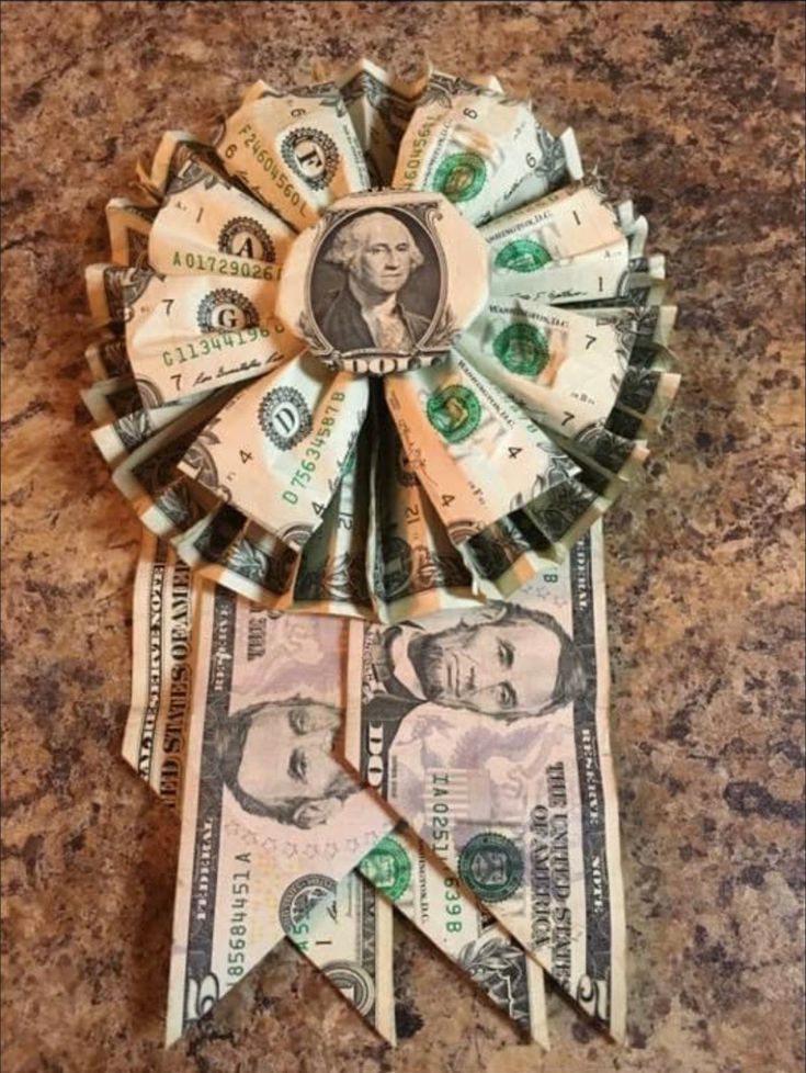 dollar bill origami fan made out of rolled up bills on top of a granite counter