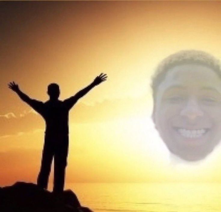 a man standing on top of a cliff with his arms outstretched in front of the sun