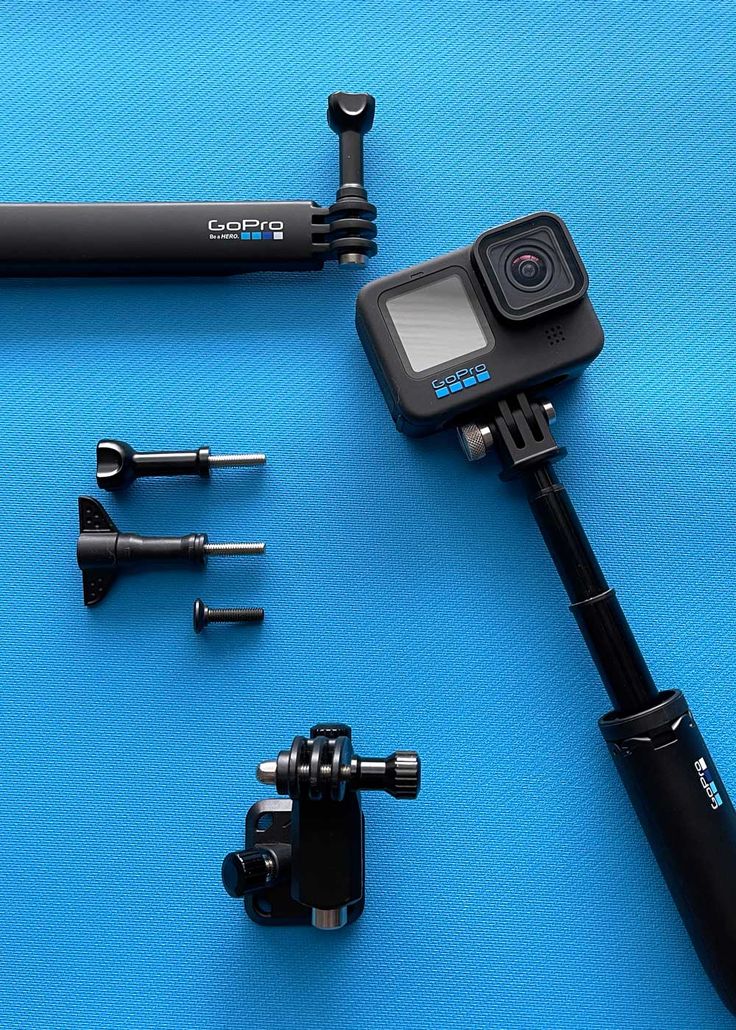 the gopro camera is set up to take pictures with other accessories on a blue surface