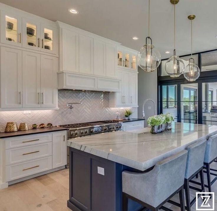 a large kitchen with an island in the middle and lots of counter space on one side