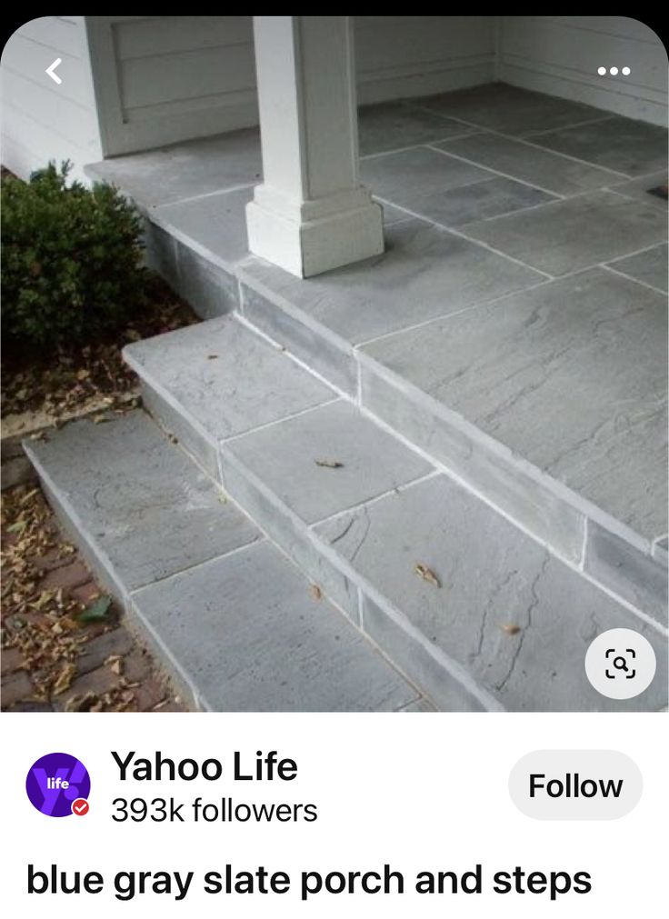 an image of someone's porch and steps that are gray slate with white trim