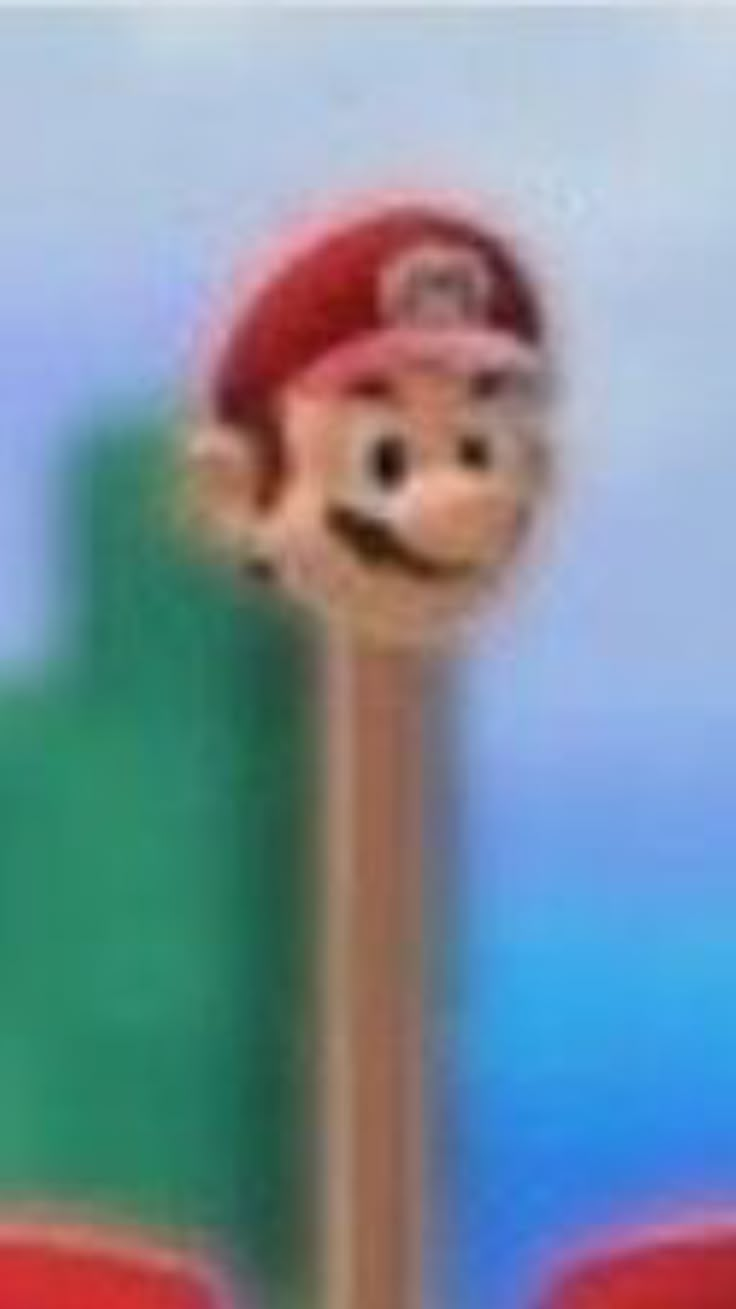 a blurry photo of a cartoon character on top of a pole