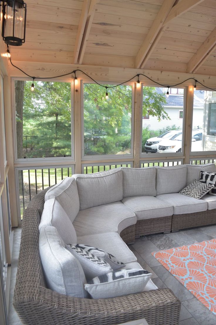 a large couch sitting on top of a covered porch