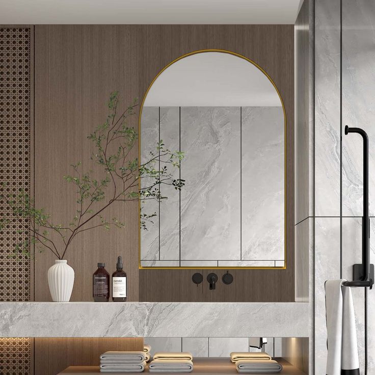 a modern bathroom with marble counter tops and gold trim around the mirror, along with two sinks