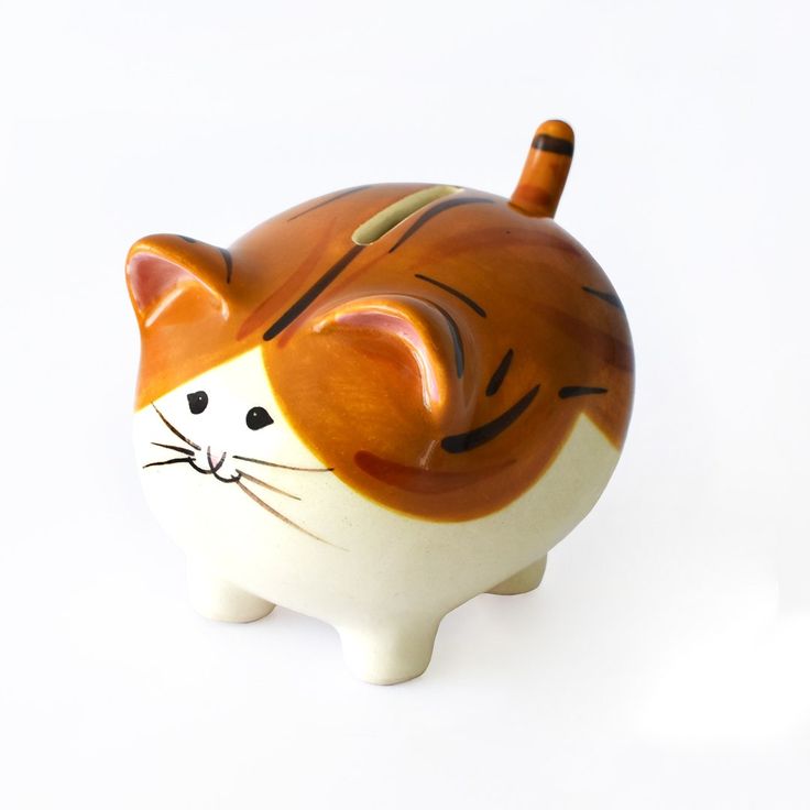 an orange and white cat figurine on a white background