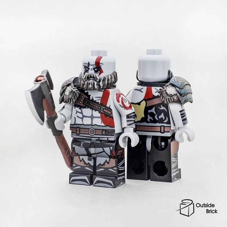 two lego figurines made to look like they are holding axes and wearing armor