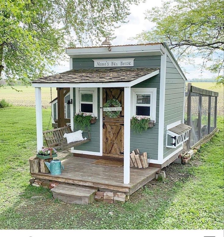 a small shed with a porch and wooden steps