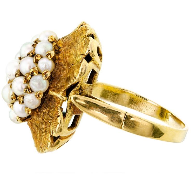 a gold ring with pearls on it