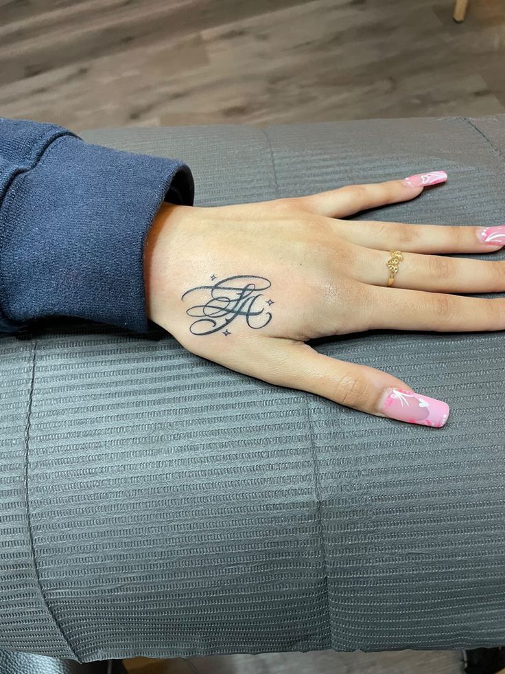 calligraphy hand tattoo Hand Tattoo Name For Women, Letter Initial Tattoo Placement, Hand Tattoo Baddie, Where To Put Name Tattoos, Thumb Tattoos Side Words, Small Letter Hand Tattoo, K Hand Tattoo, La Hand Tattoo, Initial Tattoo Hand