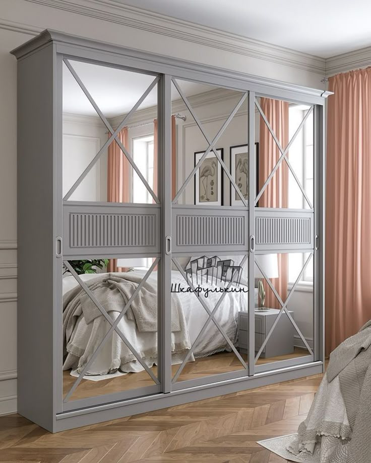 a bedroom with mirrored closet doors in the middle and pink curtains on the other side