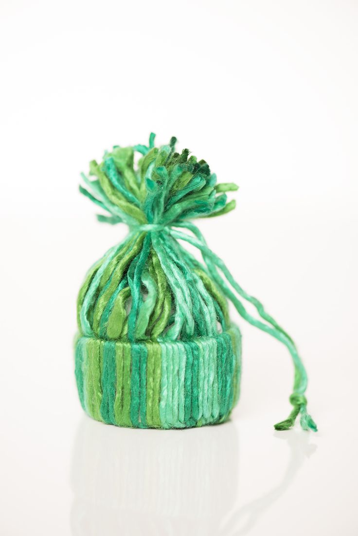 a knitted hat with green and blue yarn