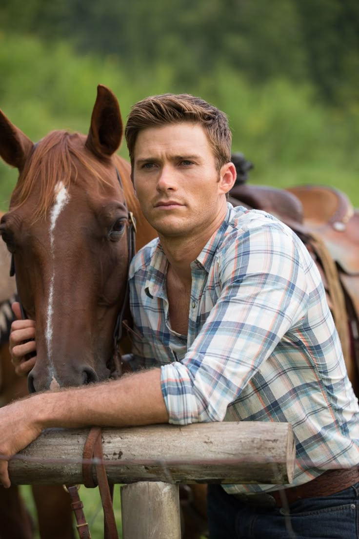 a man leaning on a fence next to a horse