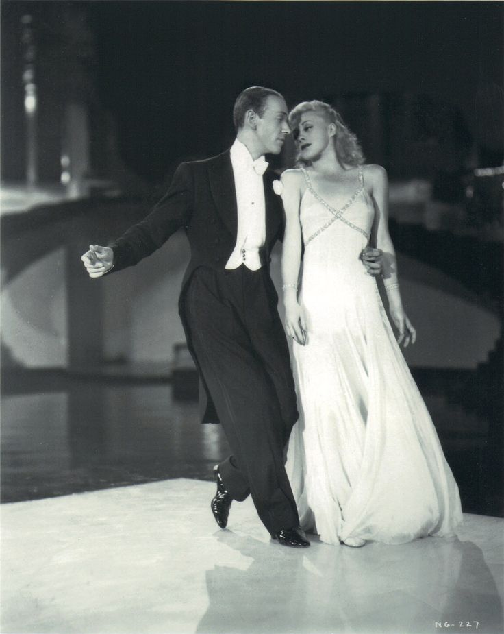 a man and woman dressed in formal wear dancing