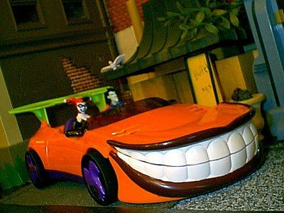 an orange toy car with teeth on it