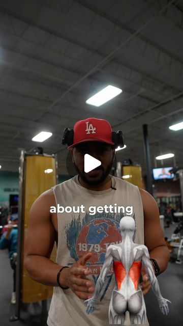 a man in a red hat is holding up a fake muscle figure with the words about getting written on it