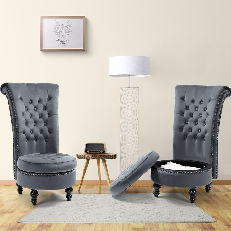 two gray chairs sitting on top of a hard wood floor next to a white rug