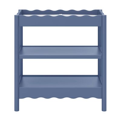 a blue wooden shelf with scalloped shelves on the top and bottom, against a white background