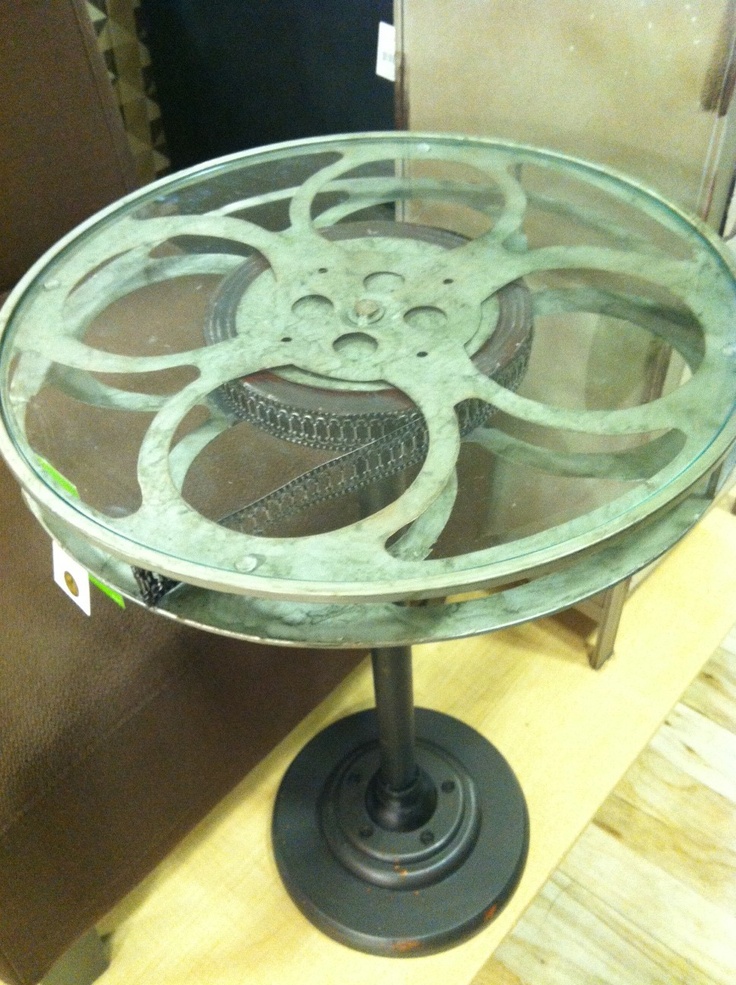 a glass table with metal wheels on it