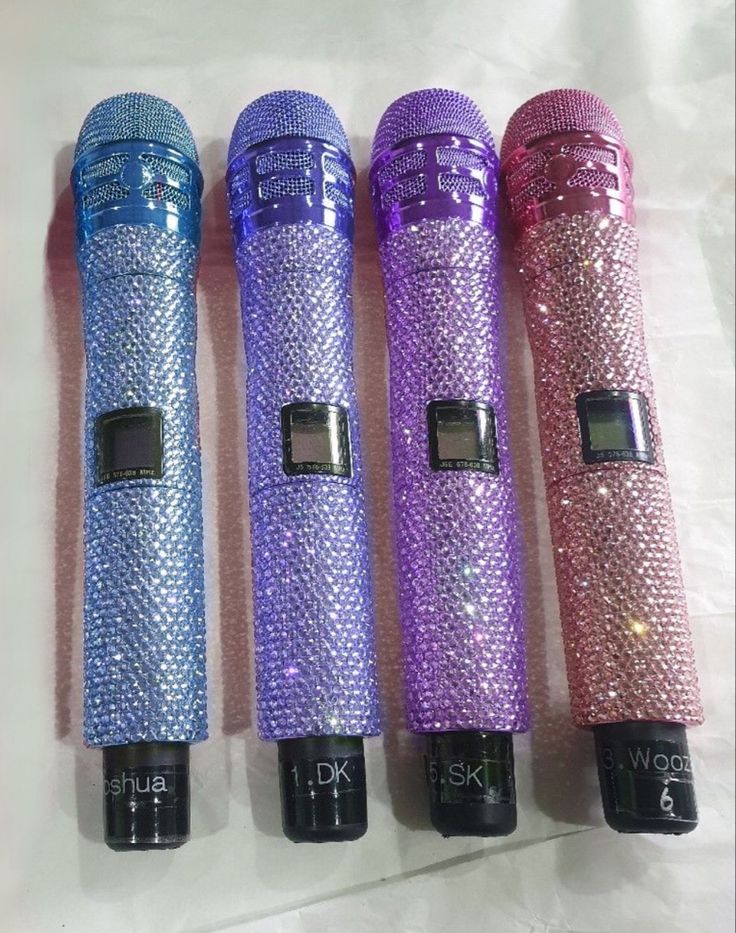 four different colored microphones sitting next to each other