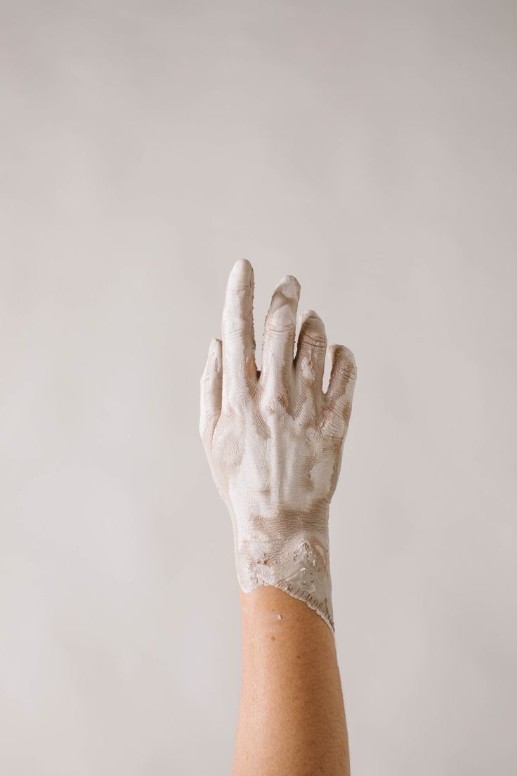 a person's hand with white paint on it