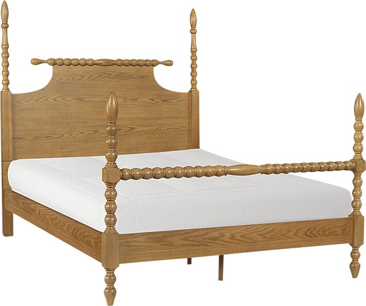 a wooden bed frame with white sheets and wood posts on the headboard is shown