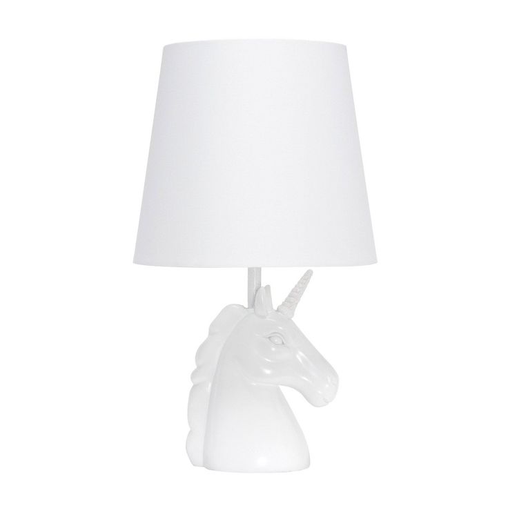 a white table lamp with a unicorn head on it