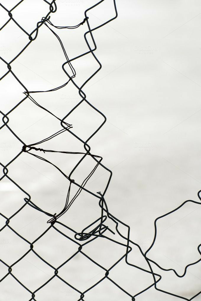 a black and white photo of a wire fence