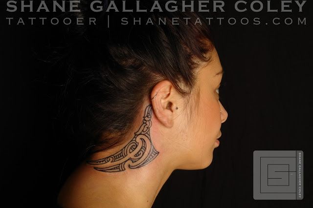 a woman with a tattoo on her neck