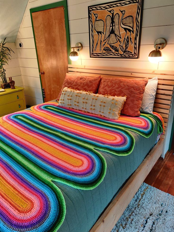 a bed with a colorful blanket on top of it