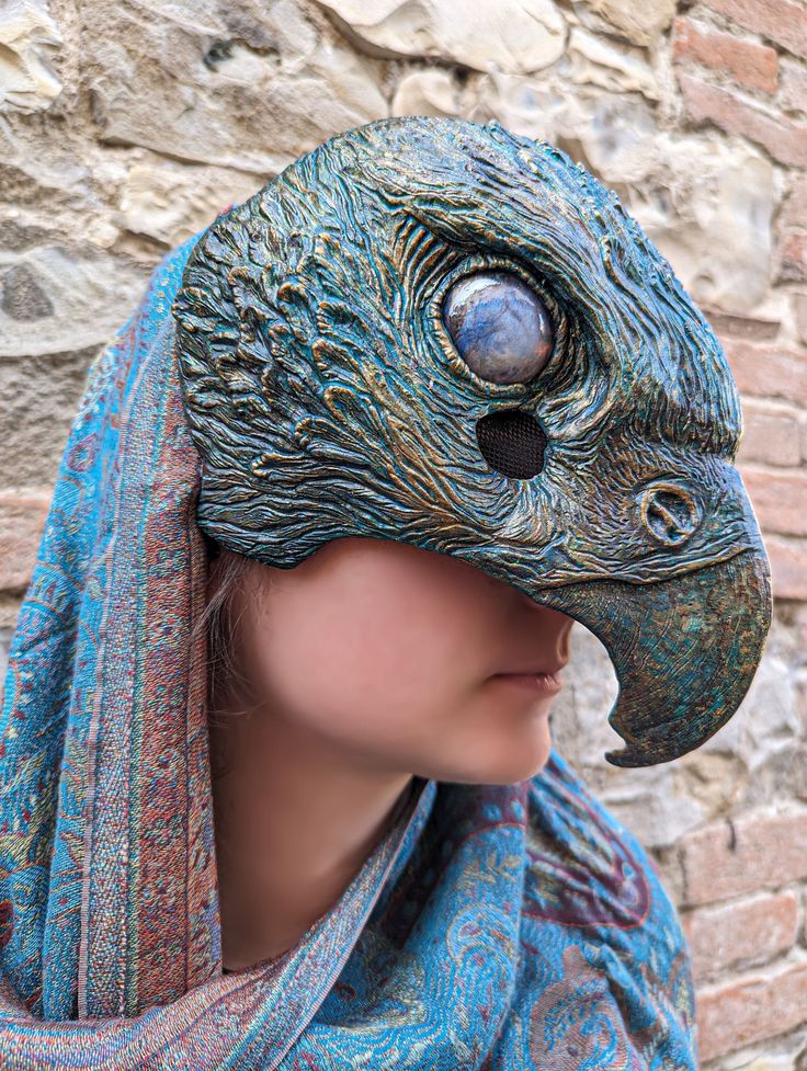 a close up of a person wearing a bird mask