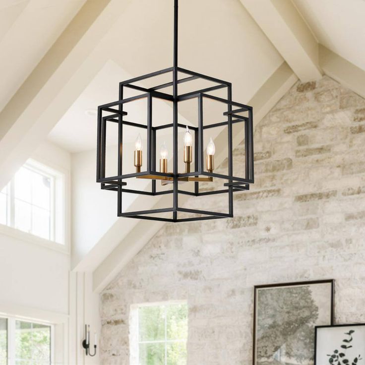 a chandelier hanging from the ceiling in a living room with exposed brick walls