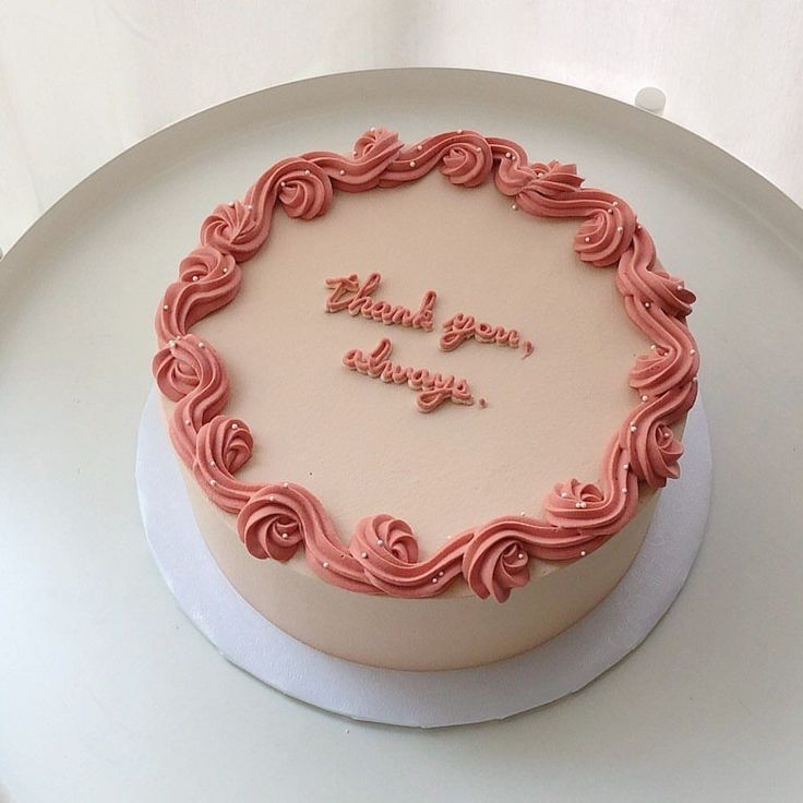 a white cake with pink frosting on top and the words thank you always written in it