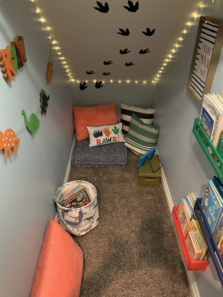 a room filled with lots of books and stuffed animals on the wall next to it