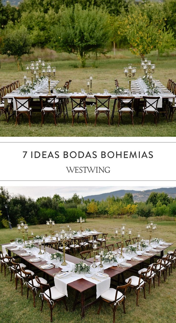 an outdoor dining table set up in the middle of a field with white flowers and greenery