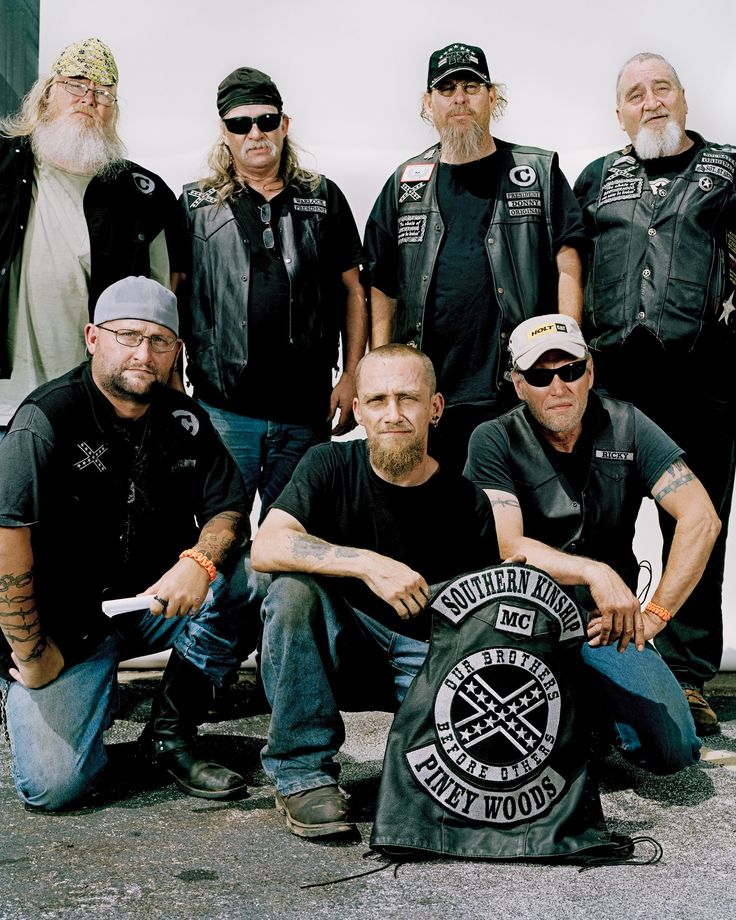 a group of bikers posing for a photo with their motorcycle gear and beards