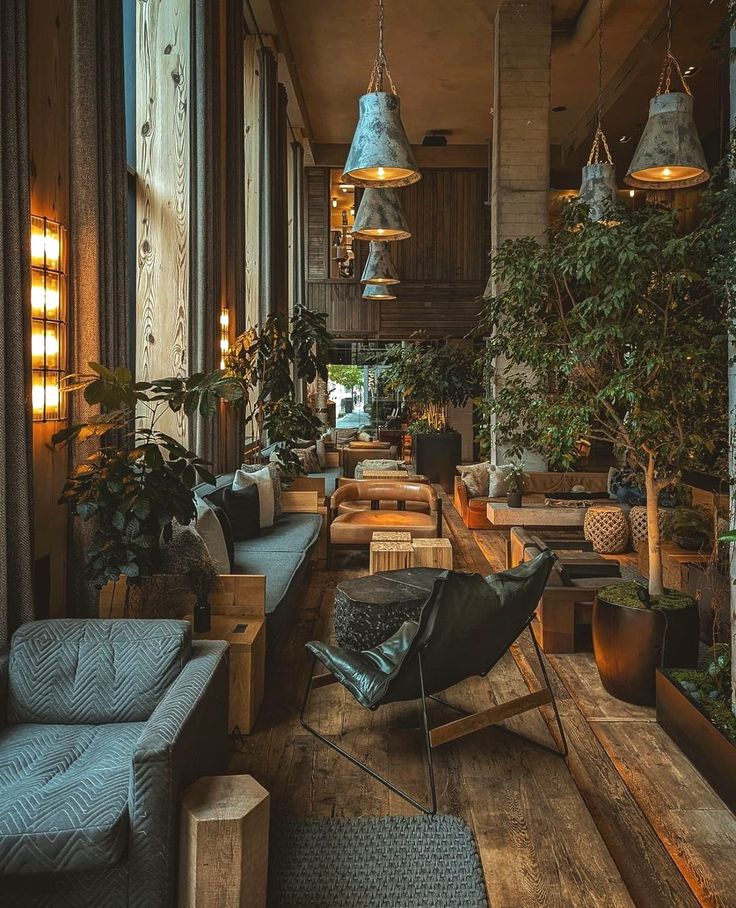 a room filled with lots of plants next to wooden flooring and walls covered in hanging lights