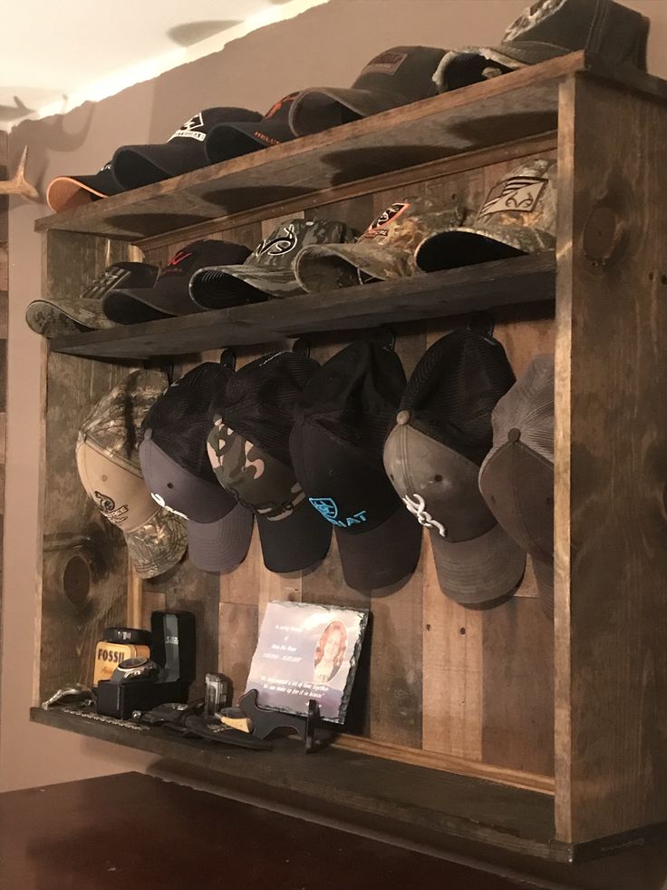 a wooden shelf filled with lots of hats