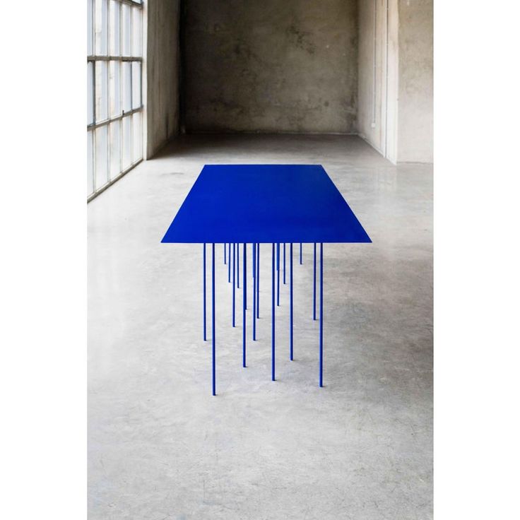 a blue table sitting in an empty room