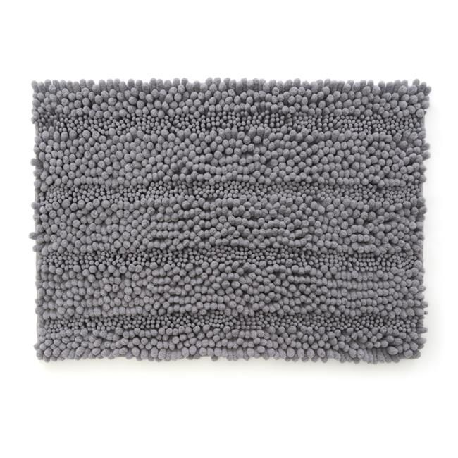 a gray rug with small balls on the bottom and one in the middle, against a white background