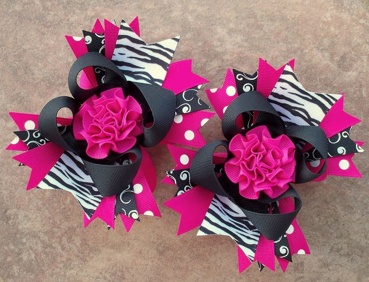 two zebra print hair bows with pink flowers